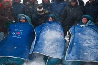 The Expedition 26 trio minutes after landing. From left to right are Russian cosmonauts Oleg Skripochka and Alexander Kaleri, both flight engineers; and NASA astronaut Scott Kelly, commander. Photo by NASA/Bill Ingalls The Expedition 26 trio minutes after landing. From left to right are Russian cosmonauts Oleg Skripochka and Alexander Kaleri, both flight engineers; and NASA astronaut Scott Kelly, commander. Photo by NASA/Bill Ingalls