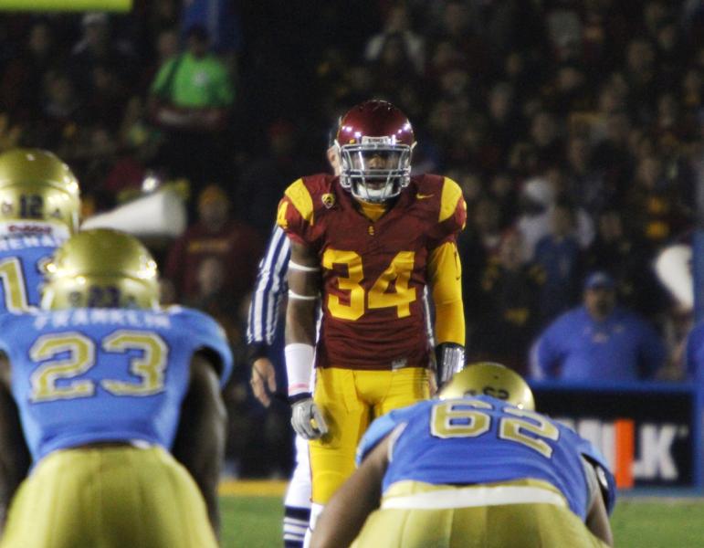 Former walk-on Tony Burnett, shown here playing safety against UCLA last season, is thriving at a new position this spring. (Shotgun Spratling)