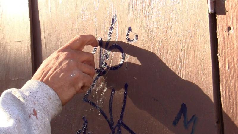 Muñoz inspects some fresh graffiti near Venice Beach