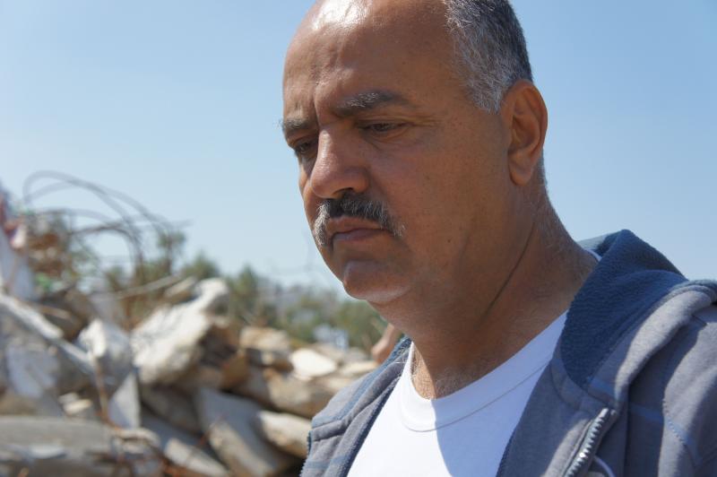 Raidh Abueid stands at the demolition site of his home. Photo by Rosalina Nieves.
