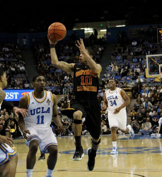 USC's Maurice Jones floats toward the basket before throwing a no-look lob pass against UCLA. (Shotgun Spratling)