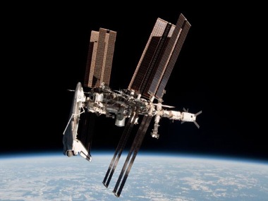 The International Space Station and docked orbiter Endeavour. Image taken by Expedition 27 astronaut Paolo Nespoli on the Soyuz TMA-20 following its undocking on May 23, 2011, USA time.