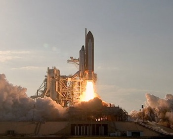 Space shuttle Discovery lifts off for STS-133 mission. Photo by NASA TV