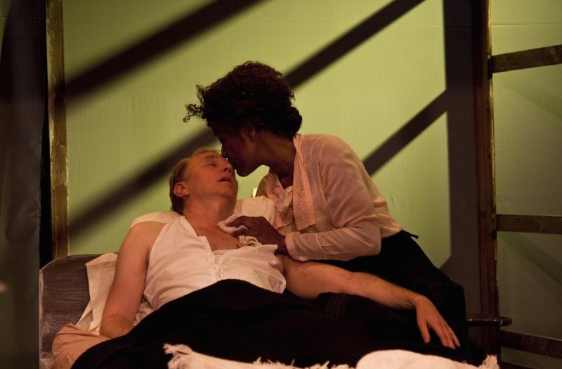 Julia (Veralyn Jones) nurses Herman (John Prosky) in her bed. (Geoffrey Wade Photography)
