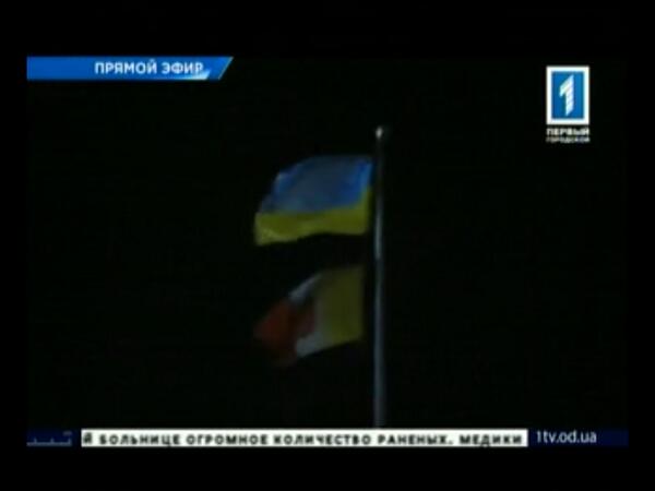 Ukrainian flag replaces the Russian flag outside the burning building. (Twitter/@Ukrblogger)