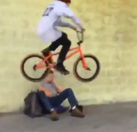 BMX bikers do tricks over homeless people. (Screenshot of Instagram video)