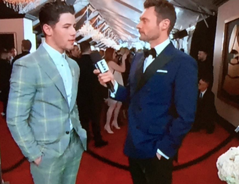 Nick Jonas with Ryan Seacrest (Twitter/ @Cosmopolitan)