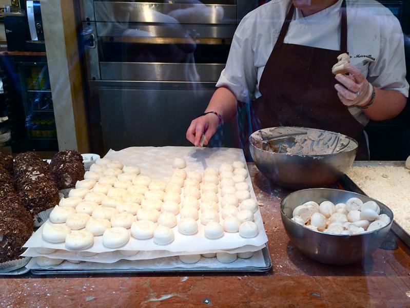 The crafting of the Merveilleuxs in the original Aux Merveilleux de Fred in Lille, France. Gracefully coating the meringue with fresh whipped cream, then coated with fine chocolate shards. (Photo courtesy of Jean-François Charrier)