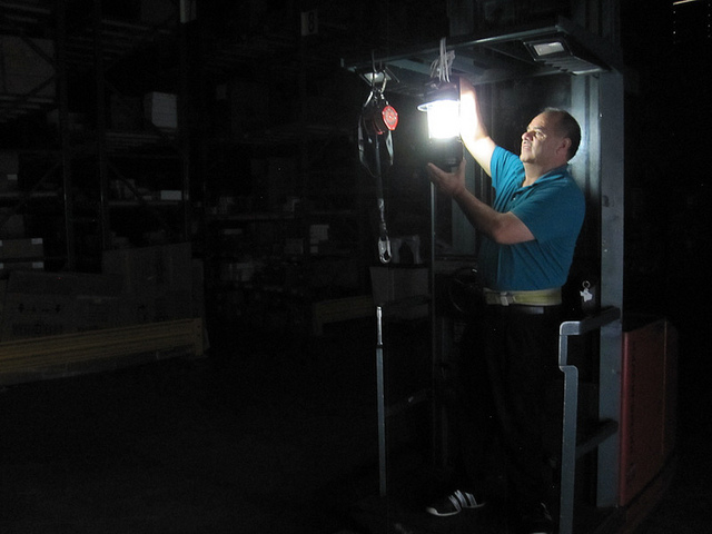 A man attempts to restore power to a company during a power outage. (Grant Wickles/ Flickr) 