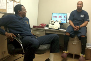 Compton firefighter and paramedic, Mark Hollomon talks about King/Drew hospital with department engineer Sam Harper. (Celeste Alvarez/Neon Tommy)