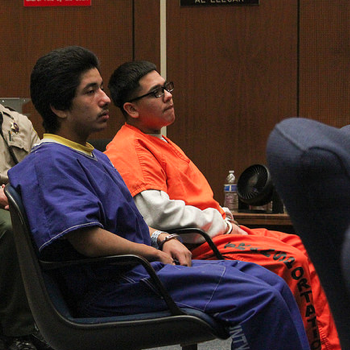 Jonathan DelCarmen, 19, (left) and Alberto Ochoa, 18, (right) listen to the court proceeding during their preliminary hearing. 