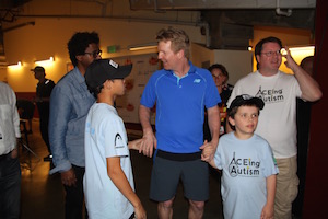 Jim Courier and Asher Major waiting to walk on court. Scarlett Zhiqi Chen / Neon Tommy.