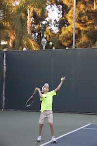 Asher serving a ball (Scarlett Zhiqi Chen/Neon Tommy)