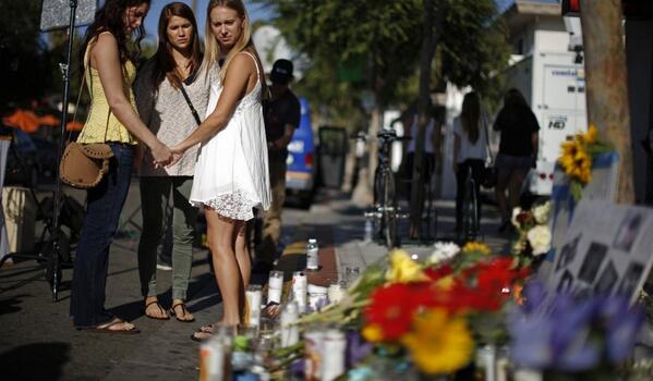 Community members mourn the shooting victims. (Twitter/@Newsweek)