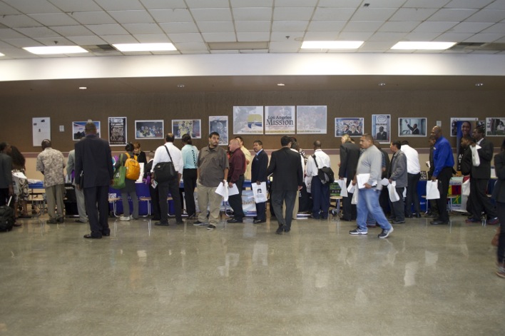 Hopeful job fair attendees line up at employers' tables. (Cassie Paton/Neon Tommy)