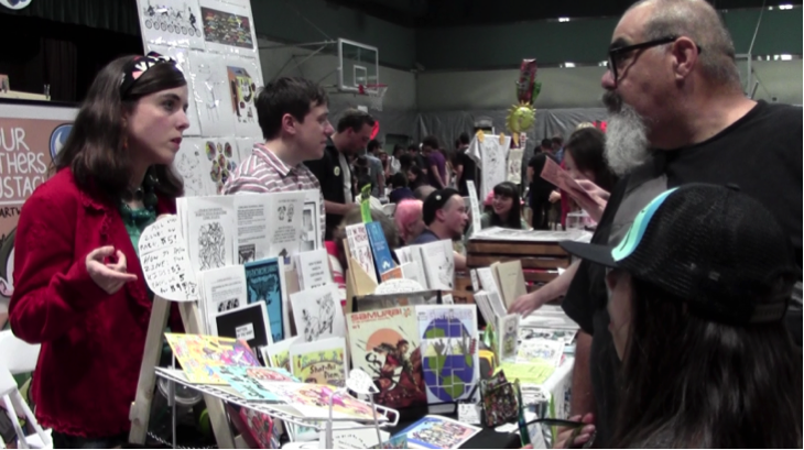 Donna Letterese explains the "punny" nature of her zines to a father and daughter. (Emily Mae Czachor/Neon Tommy)