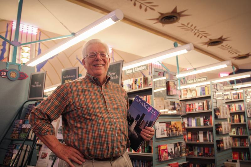 Don Allison, 74, a life-long resident of Los Angeles, holds a picture book depicting past and present pictures of Los Angeles at the Bookstar bookstore, which retains some of its old features when it was a single-screen movie theater but is now a Barnes and Noble on Friday, May 1, 2015 in Studio City, Calif. (Cameron Quon/neontommy)