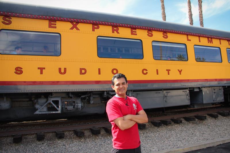 Marco Pacheco, a manager at Carney’s Express, stands in front of the train turned burger shop, which is located on Venutra Avenue on Friday, May 1, 2015 in Studio City, Calif. (Cameron Quon/neontommy)