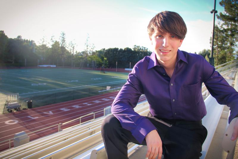 Cameron Wood, a high school senior at Harvard-Westlake, sits on the bleachers of the Ted Slavin field, which lies across the street from the planned parking structure and field on Friday, May 9, 2015 in Studio City, Calif. (Cameron Quon/neontommy)