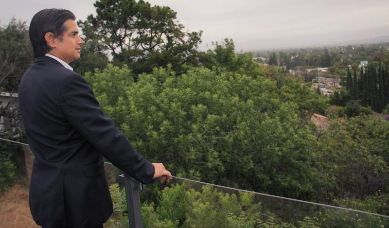 Alex Izbicki looks out onto Coldwater Canyon and Harvard Westlake from his porch. The parking structure is being proposed to be placed on his side of the street (Cameron Quon/neontommy).