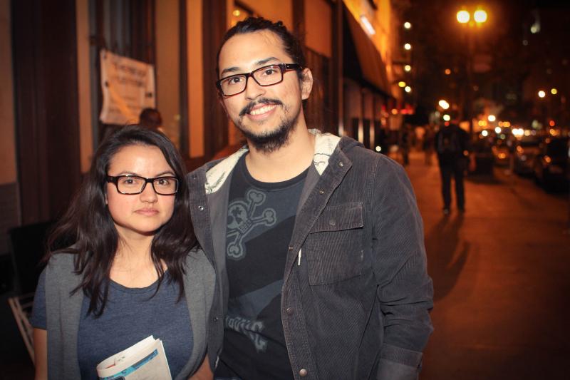 Art Walk visitors Karen Lopez (left) and Christian Raya (right) appreciate Crockett and Shaw's efforts to raise awareness about homeless veterans. (Cameron Quon/Neon Tommy)