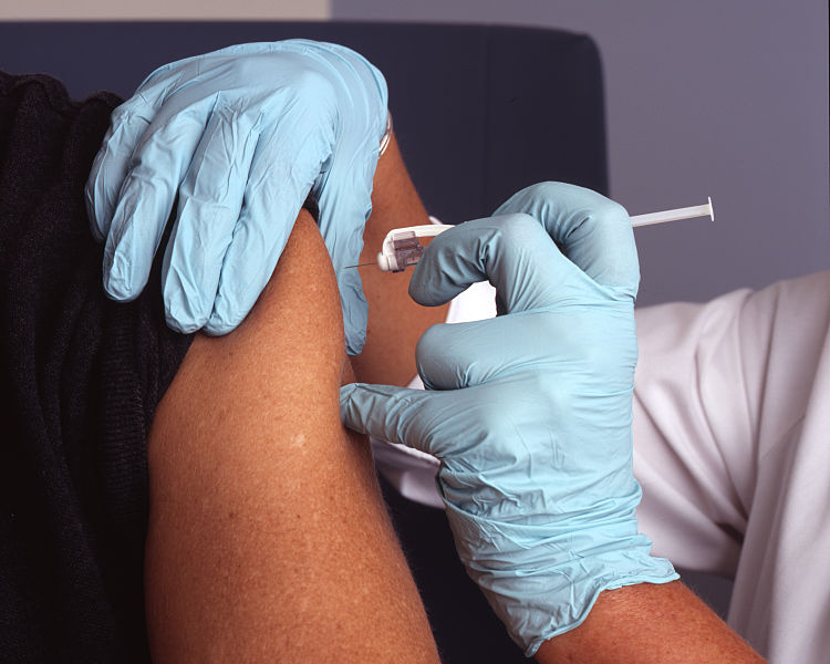 Nurse administers a vaccine (National Cancer Institute / Wikimedia Commons)