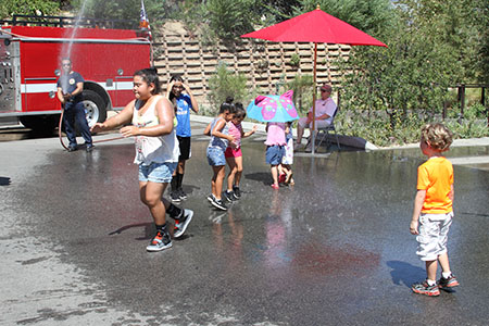Kids cool down with a little help from some firefighters (Photo by Kaitlyn Mullin)