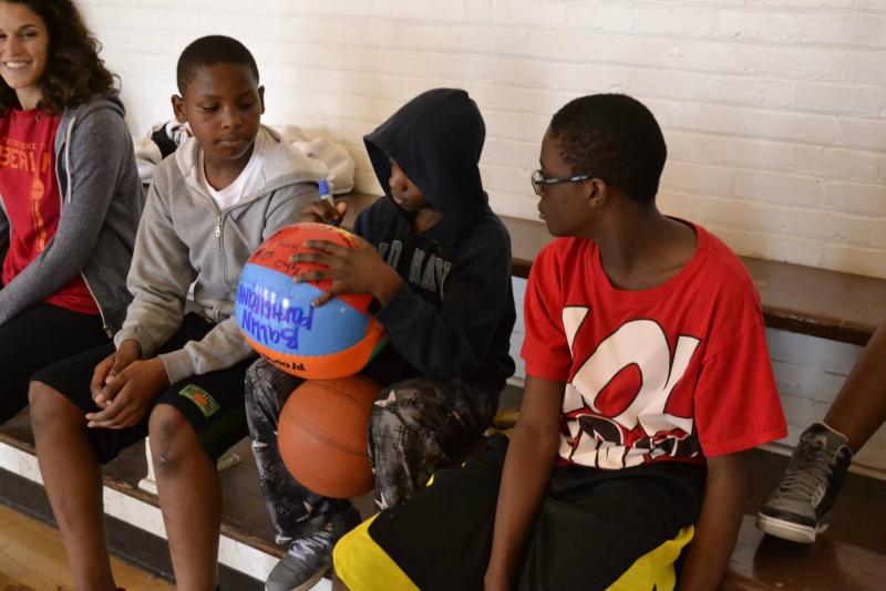 THRIVE students, Alven, Derrick and Khalil (respectively) sit after their after school program playing basketball. (courtesy of Briana Savage)