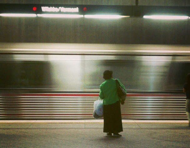 A woman watches a Red Line train arrive in Koreatown. (Matthew Tinoco/Neon Tommy)