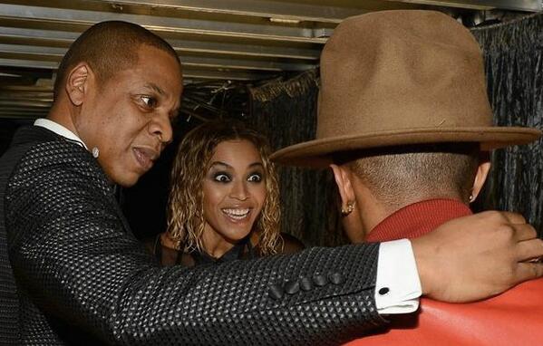 Beyonce looking at Pharrell's hat (via Twitter/@CapitalXTRA)