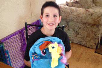 Grayson Bruce poses with his banned "My Little Pony" backpack (BileRico.com)