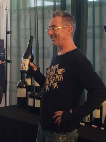 Alan Cumming holding Jonata Wine (Sonia Gumuchian/Neon Tommy)