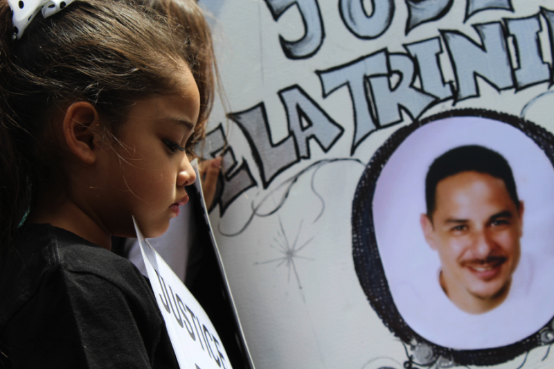 Jose de la Trinidad’s youngest daughter holds a sign that reads ‘Justice for my daddy,’ during an organized march against police brutality on April 6, 2015. (Ashley Velez/Neon Tommy)