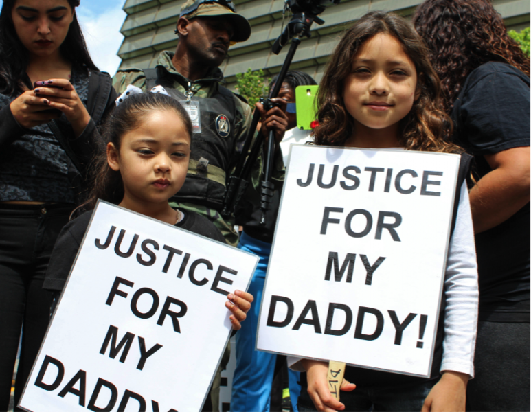 Jose de la Trinidad’s youngest daughter holds a sign that reads ‘Justice for my daddy,’ during an organized march against police brutality on April 6, 2015. (Ashley Velez/Neon Tommy) Jose de la Trinidad’s youngest daughter holds a sign that reads ‘Justice for my daddy,’ during an organized march against police brutality on April 6, 2015. (Ashley Velez/Neon Tommy)