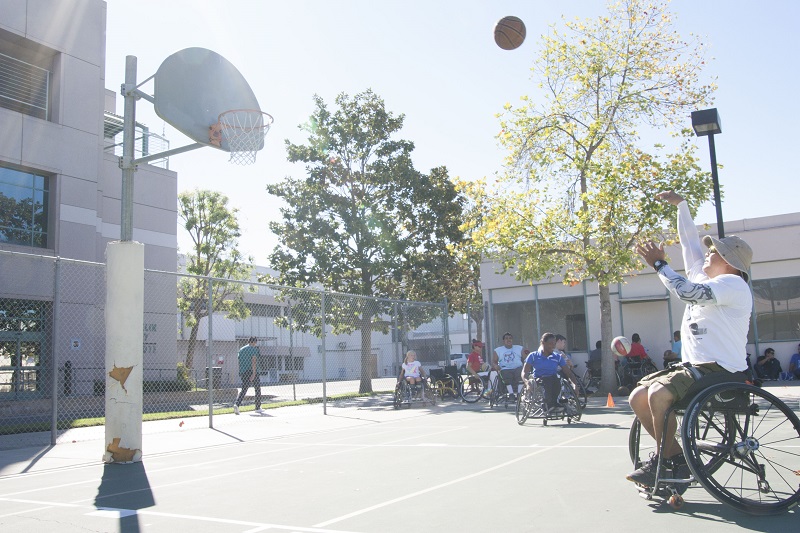 Coach Rick Tirambulo launches a basketball during a Saturday morning practice of the Rancho Renegades. (Christian Brown/Neon Tommy)