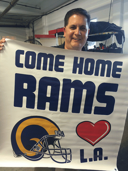 Tom Bateman with a banner he normally brings to "Bring Back the L.A. Rams" events (Marah Alindogan)