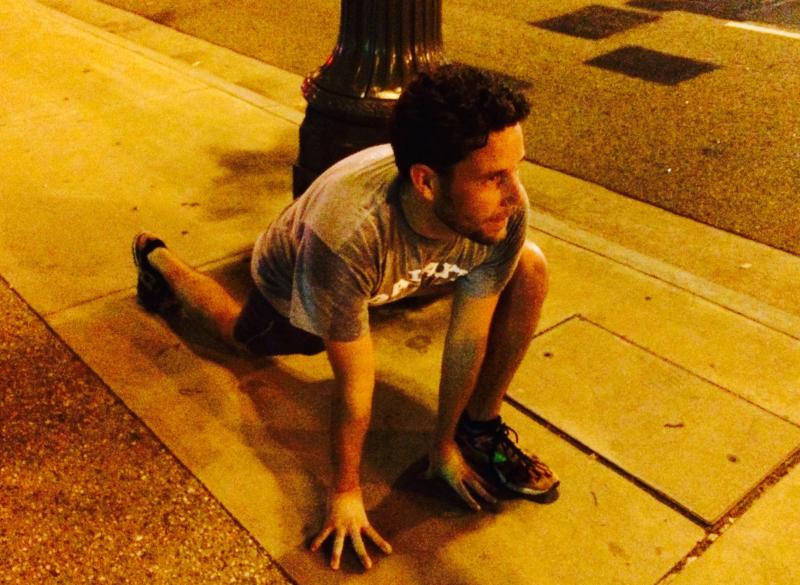 Aaron Tarbell stretched after a 4 mile run with the DTLA Running Group. (Danica Ceballos/Neon Tommy)