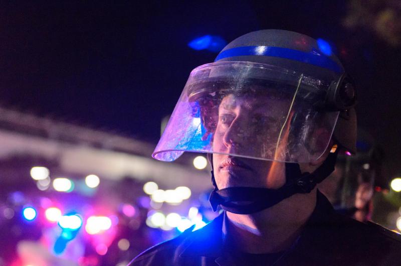 A LAPD officer watches the march. (Benjamin Dunn/Neon Tommy)