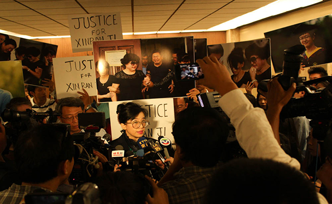 Rose Tsai, attorney for Xinran Ji’s family, speaks to reporters at the courthouse last summer, shortly following Ji’s death. (Daina Beth Solomon/Intersections)