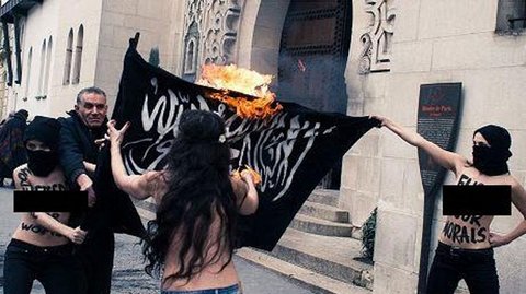 Women burn the ISIS flag in an unidentified location. (Mother Jones/Twitter)