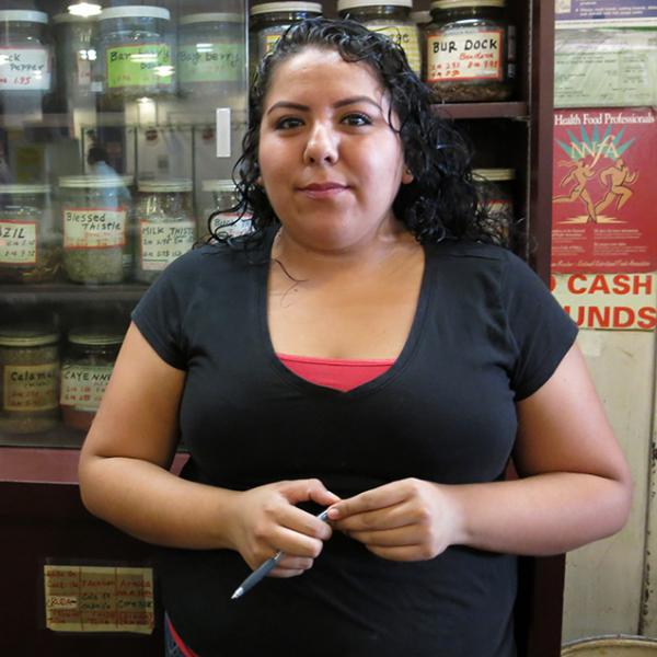 Denise Gutierrez, a sales assistant at the Grand Central Market in downtown Los Angeles, says she is paid only $8 an hour, a dollar below the legal minimum wage. (Signe Okkels Larsen)