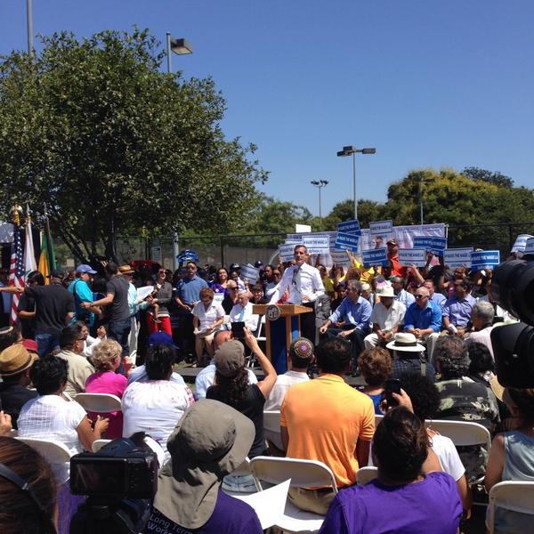 Los Angeles Mayor Eric Garcetti speaks about the minimum wage increase at the #RaiseTheWageLA rally at Martin Luther King, Jr. Park. (Jordan Plaut/Neon Tommy).