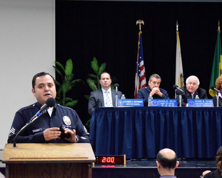 Sgt. Dan Gomez of the LAPD demonstrates the use of a body camera while Chief Charlie Beck and the Police Commission look on (Arielle Samuelson/Neon Tommy). Sgt. Dan Gomez of the LAPD demonstrates the use of a body camera while Chief Charlie Beck and the Police Commission look on (Arielle Samuelson/Neon Tommy).