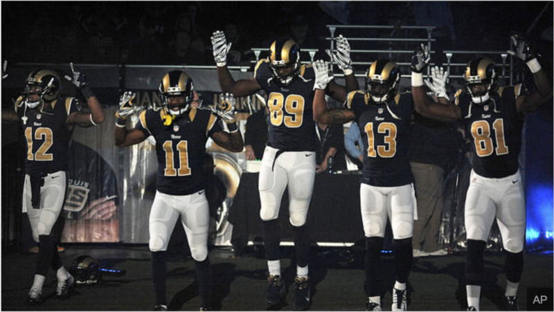 St. Louis Rams players hold their hands up on Sunday in "Hands Up, Don't Shoot" gesture. (AP Photo/L.G. Patterson)