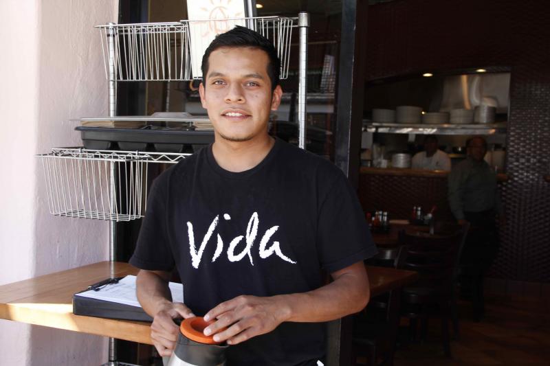 Miguel Hernan is a waiter at a coffee shop in the Pacific Palisades. "Today, you can't do a lot of things with $9," he said. (Yingzhi Yang/Neon Tommy)