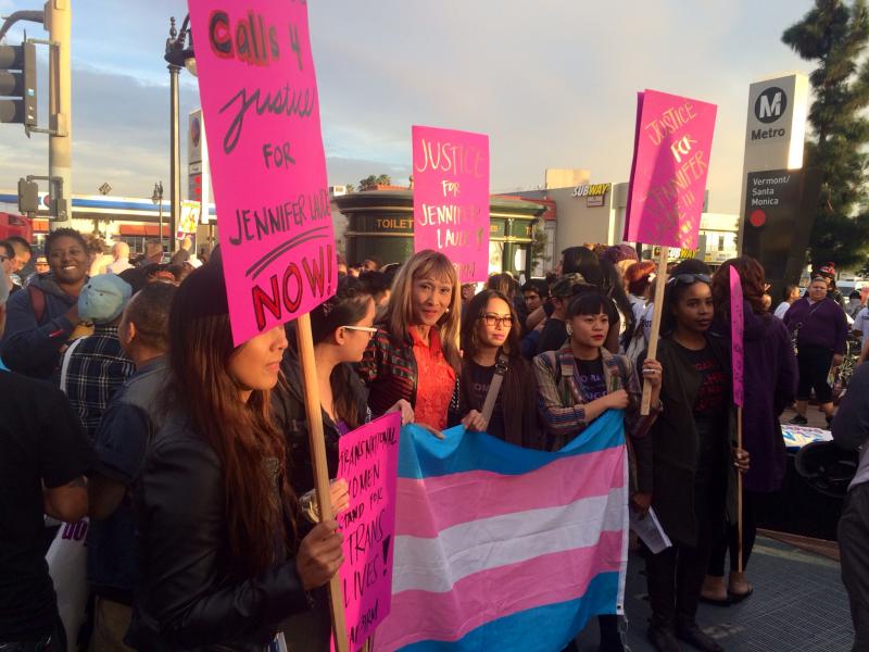 Karina Salama (center) holds up the transgender pride flag at a #TransLivesMatter rally held in November. She is a member of the LAPD transgender working group. 