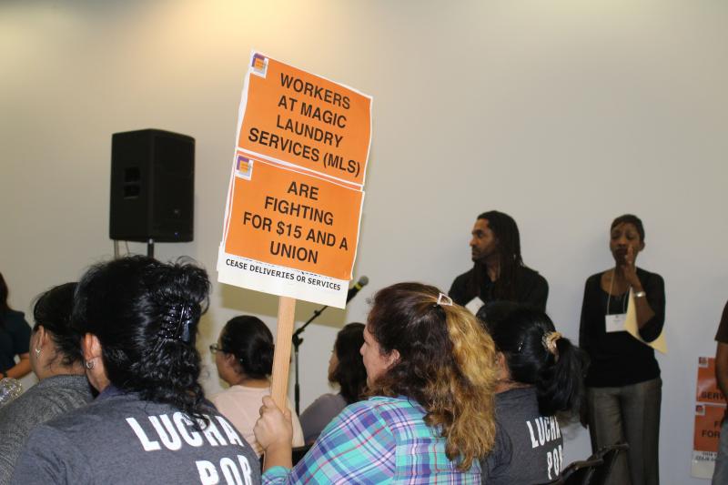 Laundry workers advocating for a higher wage attend a rally on March 31. Such a hike is being both lauded and praised across the city. (Matt Lemas / Neon Tommy)