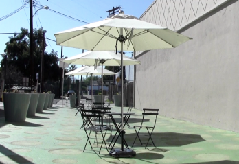 Not a single person makes use of any of the tables or chairs in NoHo Plaza during a Saturday afternoon. Not a single person makes use of any of the tables or chairs in NoHo Plaza during a Saturday afternoon.