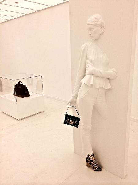 The LV accessories from past and present pop against the white room in the "Accessories Gallery" (Cassidy Waters)