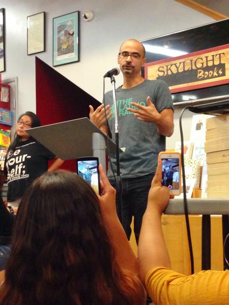 My vantage point of Junot Díaz on Friday night. The bookstore was so packed with his admirers that many of us sat on the floor to get a better view. (Eliza Moley/Neon Tommy)